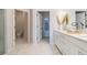 Elegant bathroom features a double vanity, modern fixtures, and seamless access to a walk-in closet and water closet at 18039 Cherished Loop, Bradenton, FL 34211