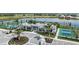 Aerial view of community clubhouse with pickleball courts and lake at 18039 Cherished Loop, Bradenton, FL 34211
