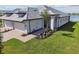 Two-car garage, tile roof, and landscaped lawn at 18039 Cherished Loop, Bradenton, FL 34211