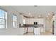 Modern kitchen with white cabinets, tile backsplash and stainless steel appliances at 18039 Cherished Loop, Bradenton, FL 34211