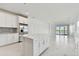 Modern kitchen with island, white cabinets, and lake view at 18039 Cherished Loop, Bradenton, FL 34211