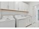 Laundry room with white cabinets, washer, and dryer at 18039 Cherished Loop, Bradenton, FL 34211
