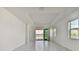 Spacious living area with tile floors and access to a tranquil water view at 18039 Cherished Loop, Bradenton, FL 34211