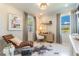 Bright home office featuring natural light, modern decor, desk space, and a stylish chaise lounge for relaxation at 18039 Cherished Loop, Bradenton, FL 34211