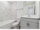 Clean bathroom with white cabinets and marble-look tile at 282 Via Anina Dr, Sarasota, FL 34243