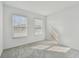 Well-lit bedroom with grey carpeting and two windows at 282 Via Anina Dr, Sarasota, FL 34243