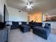 Spacious living room featuring a sectional sofa and a large TV at 7121 River Hammock Dr # 107, Bradenton, FL 34212