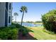 Landscaped backyard with pond and lush greenery view at 7121 River Hammock Dr # 107, Bradenton, FL 34212