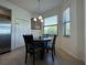 Cozy breakfast nook with a round table and four chairs, overlooking nature at 7121 River Hammock Dr # 107, Bradenton, FL 34212