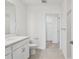 Bathroom with vanity, toilet, and walk-in closet at 7428 Cabin Ln, Sarasota, FL 34240