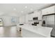 Modern white kitchen with stainless steel appliances and a large center island at 7428 Cabin Ln, Sarasota, FL 34240