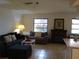 Cozy living room featuring a sectional sofa, fireplace, and tiled floors at 1608 Bob O Link Dr, Venice, FL 34293