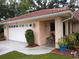 Attached two-car garage with white door and decorative lighting at 1608 Bob O Link Dr, Venice, FL 34293