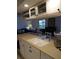 Kitchen with double sink, overhead cabinets, and breakfast bar at 1608 Bob O Link Dr, Venice, FL 34293
