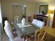 Dining room with a glass-top table and a stone fireplace nearby at 1608 Bob O Link Dr, Venice, FL 34293