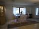 Dining area with a glass-top table and access to a sunroom at 1608 Bob O Link Dr, Venice, FL 34293