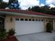 White two-car garage with decorative lighting and house number at 1608 Bob O Link Dr, Venice, FL 34293