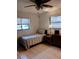 Small bedroom with twin bed, dresser, and ceiling fan at 1608 Bob O Link Dr, Venice, FL 34293