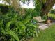 Lush, garden-like backyard with a shaded seating area at 1608 Bob O Link Dr, Venice, FL 34293
