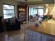 Kitchen with breakfast bar, view of sunroom and backyard at 1608 Bob O Link Dr, Venice, FL 34293