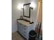 Bathroom with vanity, mirror, and tiled walls at 1608 Bob O Link Dr, Venice, FL 34293