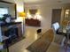 Living room featuring a stone fireplace and a dining area at 1608 Bob O Link Dr, Venice, FL 34293