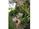 Relaxing front yard with lush landscaping, a bench, and decorative pots at 1608 Bob O Link Dr, Venice, FL 34293