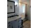 Bathroom with vanity, mirror, and tiled walls at 1608 Bob O Link Dr, Venice, FL 34293
