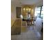Dining room with a glass-top table and a light-colored hutch at 1608 Bob O Link Dr, Venice, FL 34293