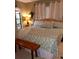 King-size bed in a well-lit bedroom with seashell-themed bedding at 1608 Bob O Link Dr, Venice, FL 34293