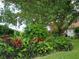 Landscaped border showcasing a variety of colorful plants and ferns at 1608 Bob O Link Dr, Venice, FL 34293
