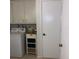 Laundry room with washer, dryer, and storage cabinets at 1608 Bob O Link Dr, Venice, FL 34293