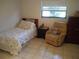 Small bedroom with twin bed and recliner chair at 1608 Bob O Link Dr, Venice, FL 34293