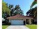 Single-story home with a two-car garage and Spanish tile roof at 1608 Bob O Link Dr, Venice, FL 34293