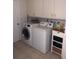 Clean laundry room with stacked washer and dryer at 1608 Bob O Link Dr, Venice, FL 34293