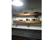 Rustic wood shelves add character to this modern kitchen at 1480 17Th St, Sarasota, FL 34234