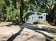 Gray house surrounded by trees and greenery at 1480 17Th St, Sarasota, FL 34234