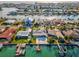 Aerial view of waterfront home with pool and private dock, showcasing desirable location at 11755 5Th E St, Treasure Island, FL 33706