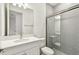 Modern bathroom with grey subway tile, glass shower door and bright white vanity at 17340 Savory Mist Cir, Bradenton, FL 34211