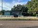 Quaint teal home with carport and white picket fence at 2415 E 21St Ave, Tampa, FL 33605