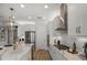 Modern kitchen with white cabinets, quartz countertops, and stainless steel appliances at 289 Vistera Blvd, Nokomis, FL 34275