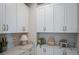 Bright laundry room with white cabinets and modern appliances at 289 Vistera Blvd, Nokomis, FL 34275