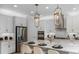 Modern kitchen with white cabinets, quartz countertops, and stainless steel appliances at 289 Vistera Blvd, Nokomis, FL 34275
