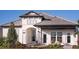 Two-story house with gray tile roof, white exterior, and landscaping at 289 Vistera Blvd, Nokomis, FL 34275