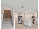 Modern kitchen with stainless steel appliances and an island, view of stairs at 5439 Tripoli Dr, Palmetto, FL 34221