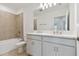 Bathroom with double vanity, tub, and tile shower at 5439 Tripoli Dr, Palmetto, FL 34221