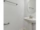Simple bathroom with pedestal sink, round mirror, and modern fixtures at 5439 Tripoli Dr, Palmetto, FL 34221