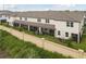 Townhouse rear elevation showcasing screened patio, fenced yard, and landscaping at 5439 Tripoli Dr, Palmetto, FL 34221
