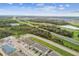 Wide aerial view of the community and surrounding areas, showing nearby roads and nature at 5439 Tripoli Dr, Palmetto, FL 34221