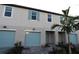 Modern townhouse with light blue garage doors at 5439 Tripoli Dr, Palmetto, FL 34221